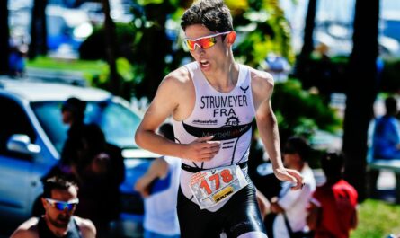 A young man completes a triathlon, a specific part of running.